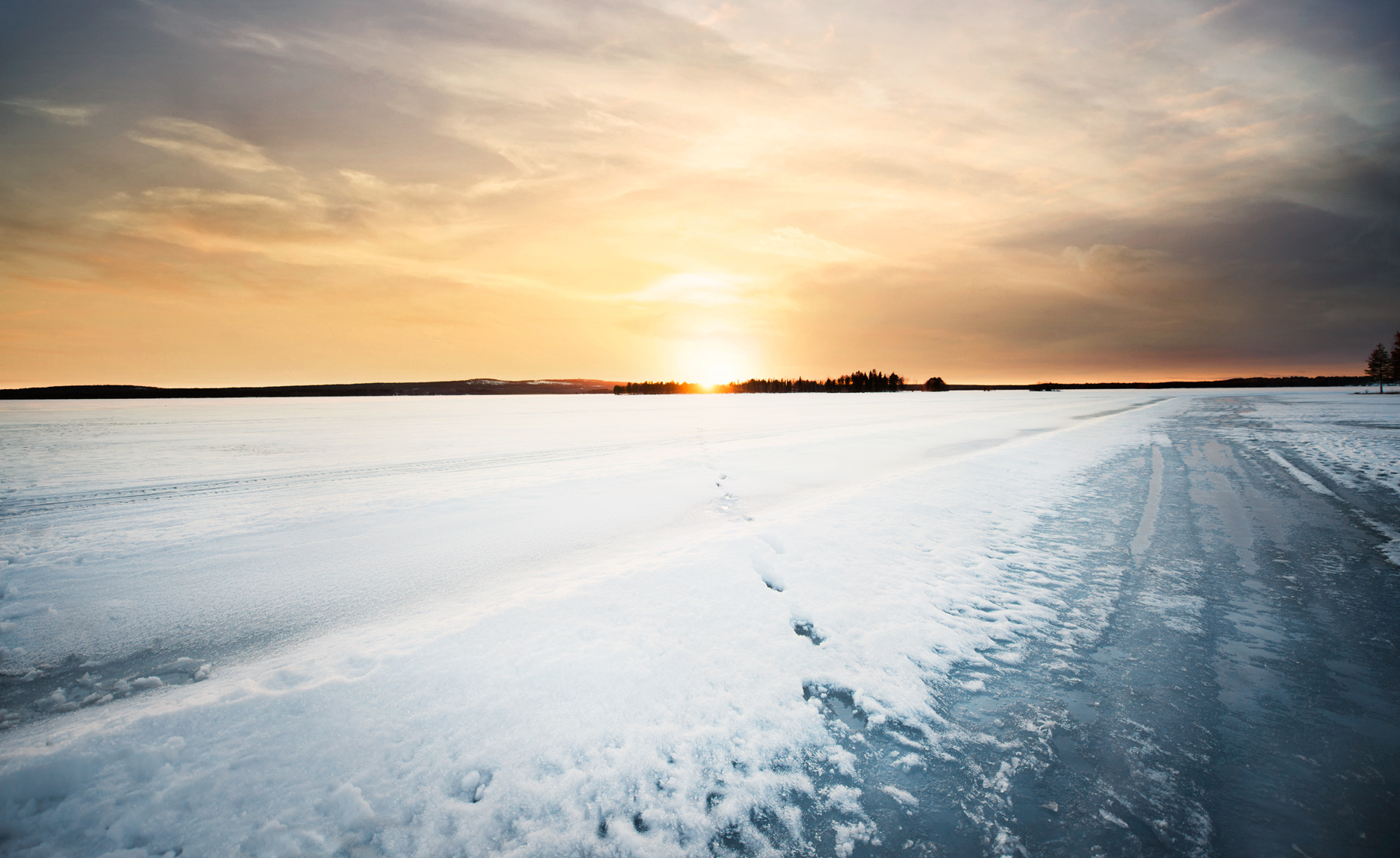 Snowy footprints on sunset 